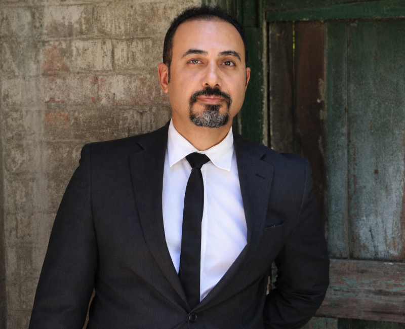 Dr Ata Tara, GeoArt artist, landscape architect and geodesign researcher, wearing a dark suit in a professional portrait.